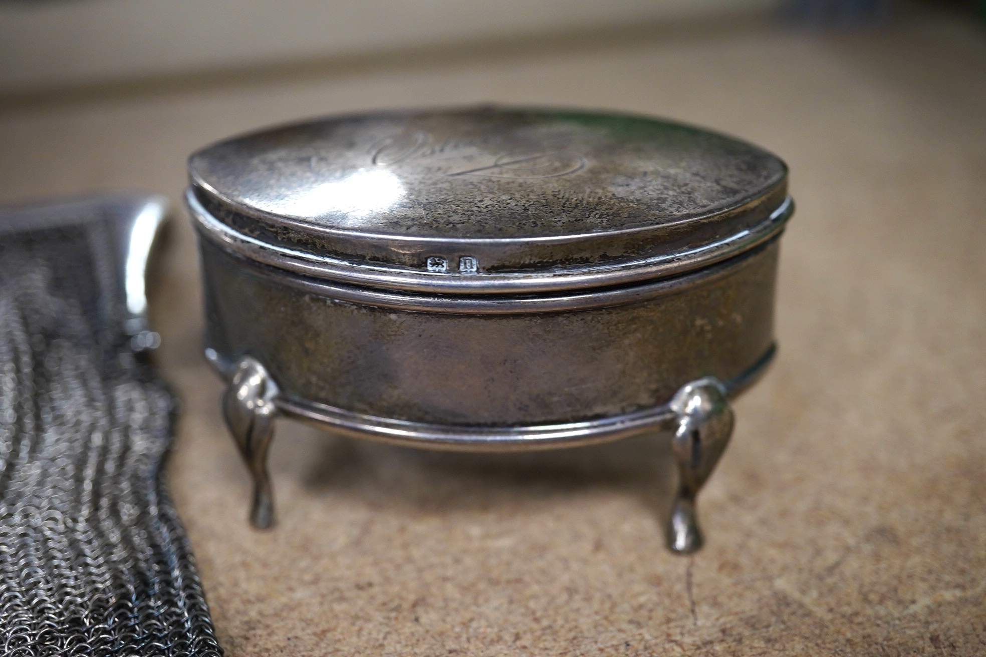 A George V silver trinket box, 68mm, a silver vesta case and two silver mesh evening bags. Condition - poor to fair